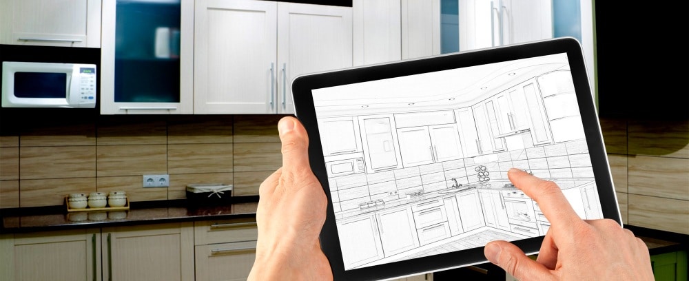 une personne travaillant sur une tablette tactile affichant un logiciel de décoration intérieur